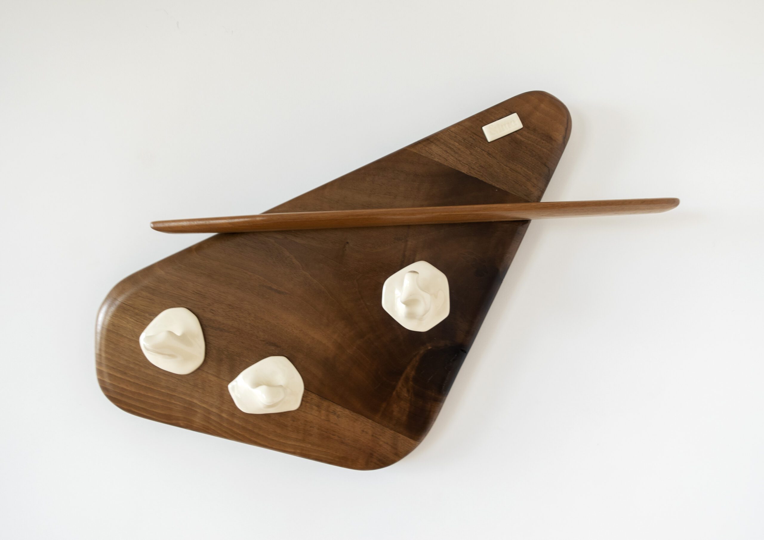 walnut wood coat rack with porcelain hangers