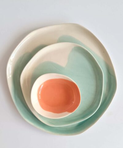 plates and a small bowl in turquoise and salmon